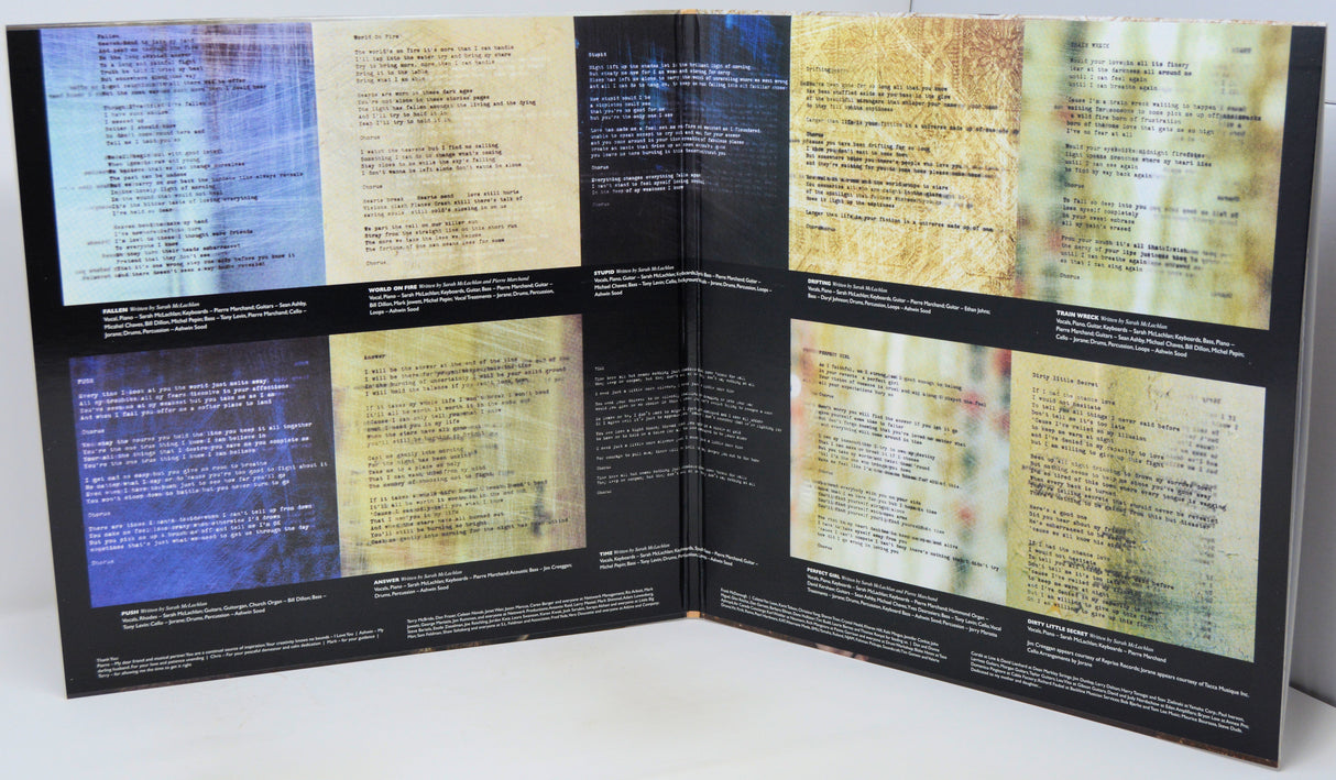 An open booklet or album-style printed spread with six abstract panels containing text, photographed against a plain light background.
