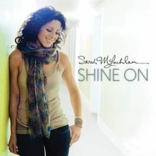 Album cover with a person wearing a colorful scarf and text 'Shine On' by Sarah McLachlan.