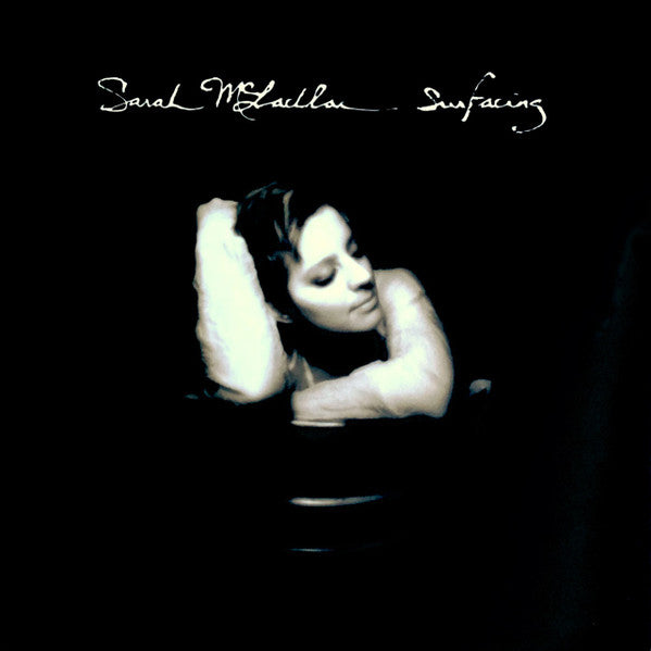 Album cover with a person lying on the ground, text 'Sarah McLachlan Surfacing' at the top.