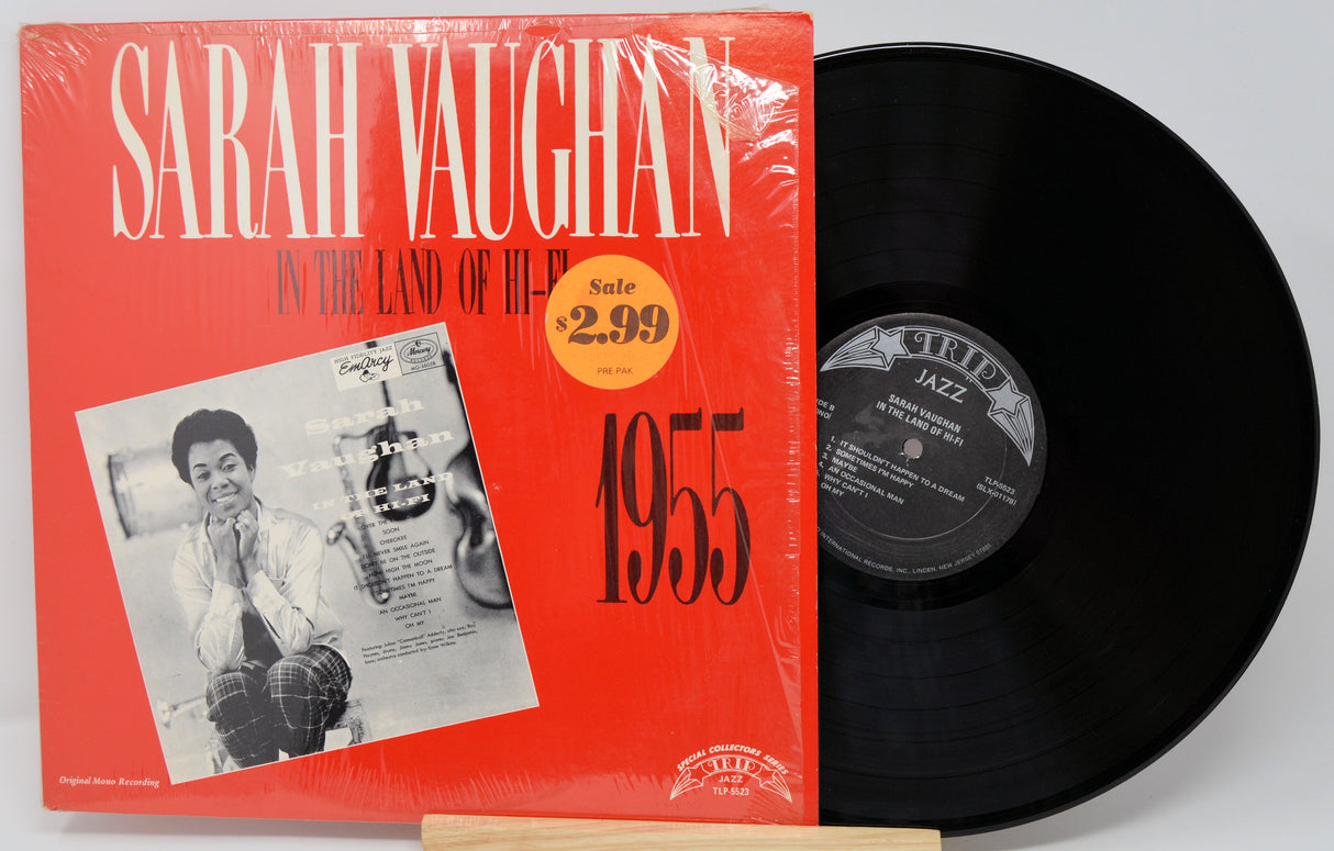Vinyl record with red cover featuring 'Sarah Vaughan' and a black record on a white background