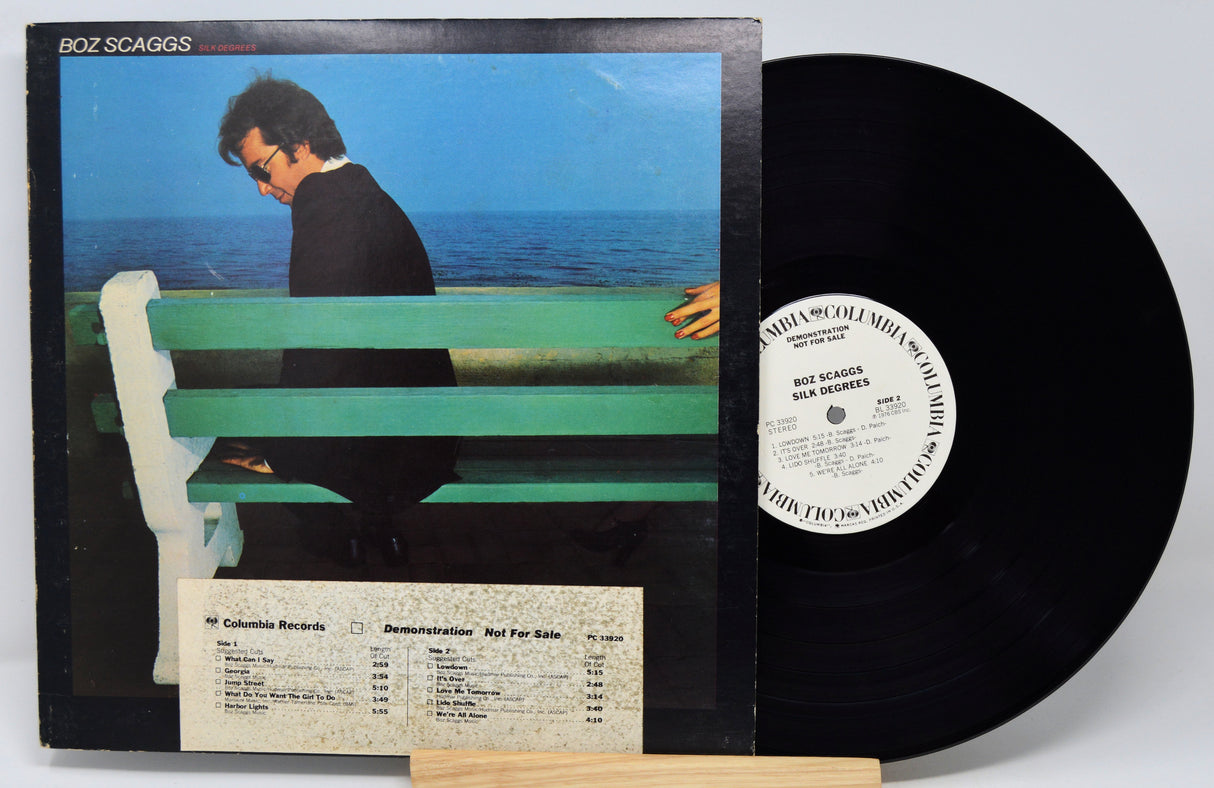 Vinyl record with cover featuring a person on a bench by the ocean, Boz Scaggs album.