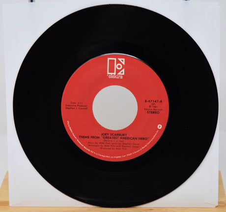 Vinyl record with red label on a white background