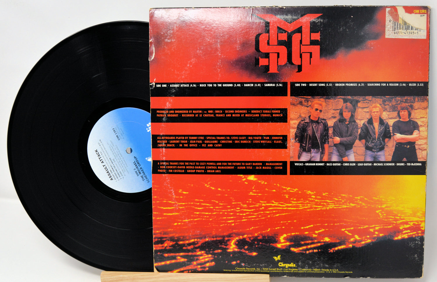 Vinyl record with a colorful cover featuring a band and text.