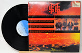 Vinyl record with a colorful cover featuring a band and text.