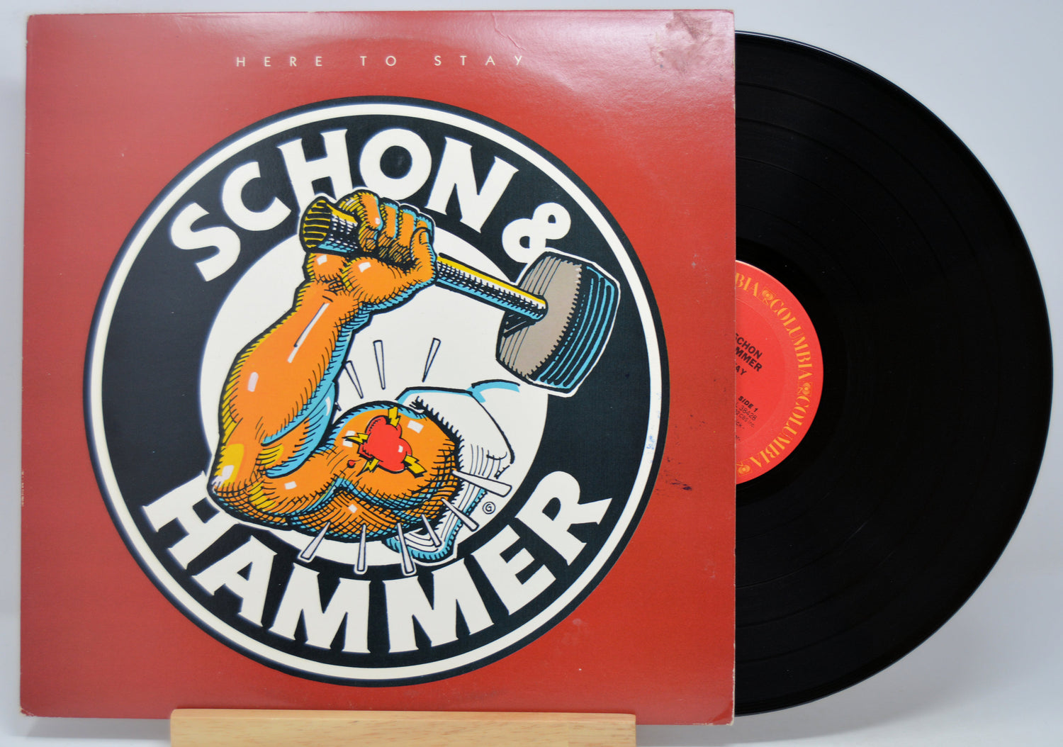 'Schon Hammer Here To Stay' Vinyl record with album cover featuring an arm holding a hammer, red background and black vinyl disc.