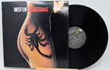 Vinyl record with a scorpion tattoo on a person's arm and album cover displaying 'Best of Scorpions' text.