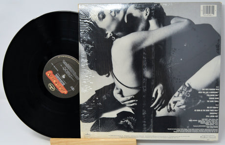 Vinyl record with a black and white cover featuring an intimate pose.