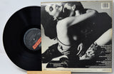 Vinyl record with a cover featuring a black and white image of two people embracing.