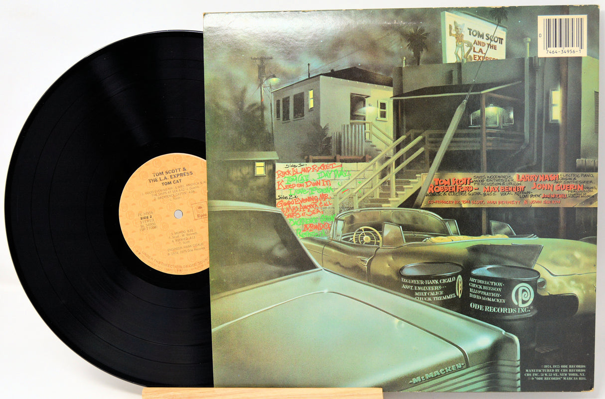 Vinyl record with cover featuring a car and urban scene