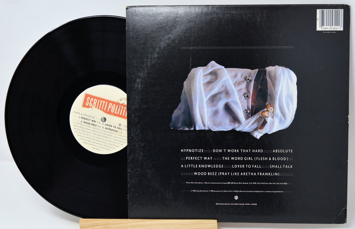 Vinyl record with cover featuring a person in white clothing on a gray background