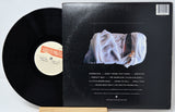 Vinyl record with cover featuring a person in white clothing on a gray background