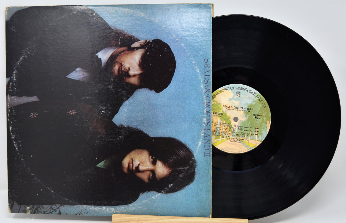 Vinyl record with a blue cover featuring two people and a visible label.