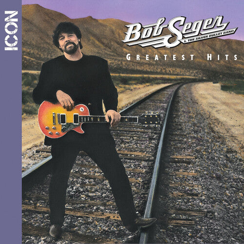 Album cover with a person holding a guitar on train tracks, featuring 'Bob Seger & The Silver Bullet Band' and 'Greatest Hits'.