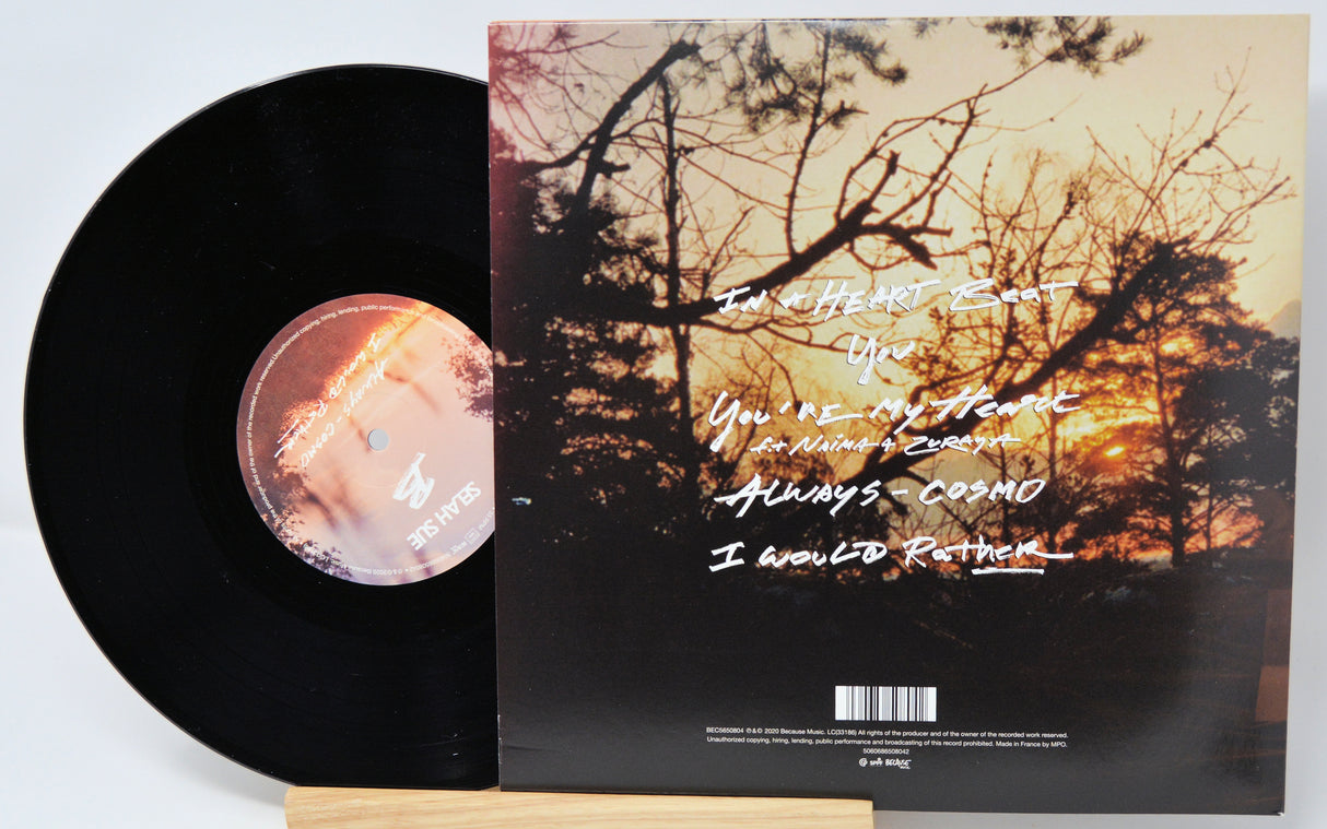 Vinyl record with cover featuring a sunset and text
