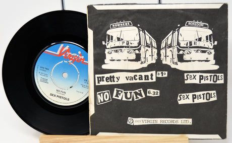 Vinyl record and cover with 'Sex Pistols' design on a white background