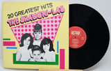 Vinyl record with cover featuring '20 Greatest Hits' by The Shangri-Las on a yellow background.