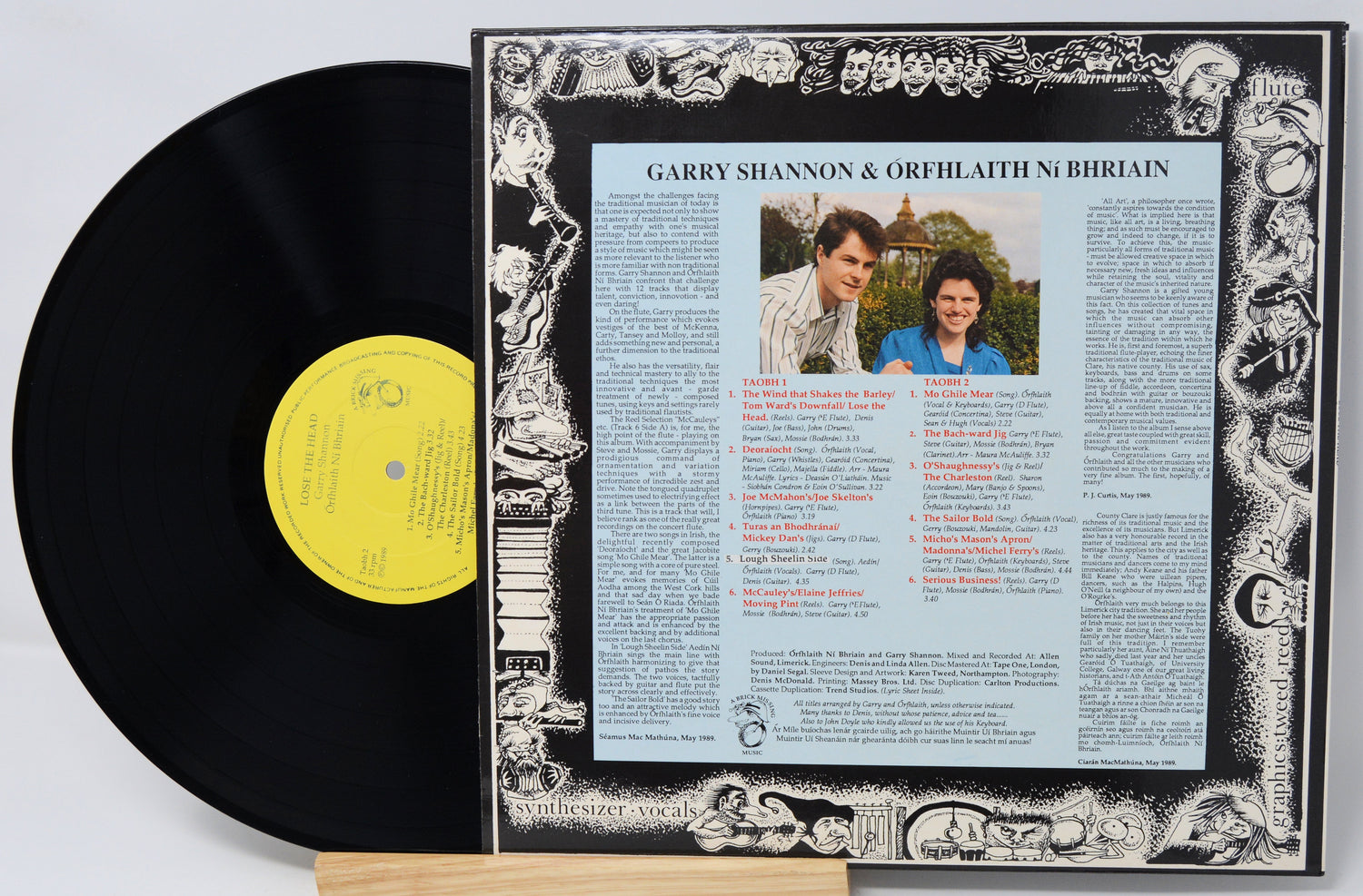 Vinyl record with a detailed cover featuring text and images of two people.