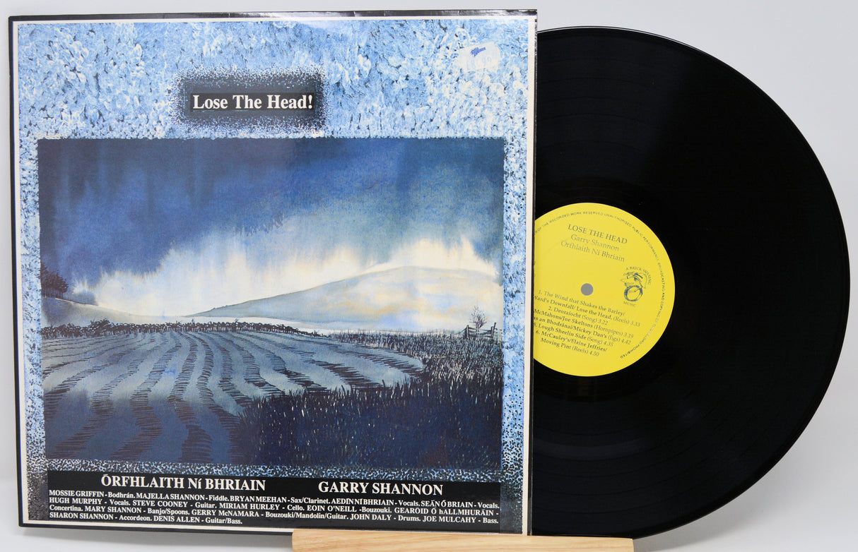 Vinyl record with cover featuring a landscape and text 'Lose The Head!'