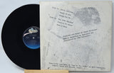 Vinyl record with white label and Epic Records logo on a light gray background