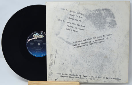 Vinyl record with white label and Epic Records logo on a light gray background