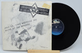 Vinyl record with a black and white cover featuring text and a logo.