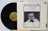 Vinyl record with cover featuring a black and white photo of a man and text.
