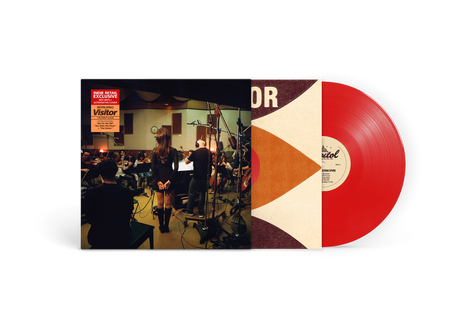 Vinyl record with a colorful cover featuring a band and text on a white background