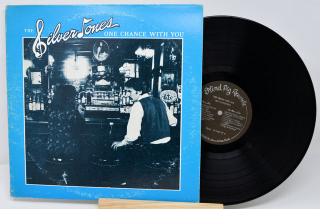 Vinyl record with cover featuring a person in a bar, on a white background