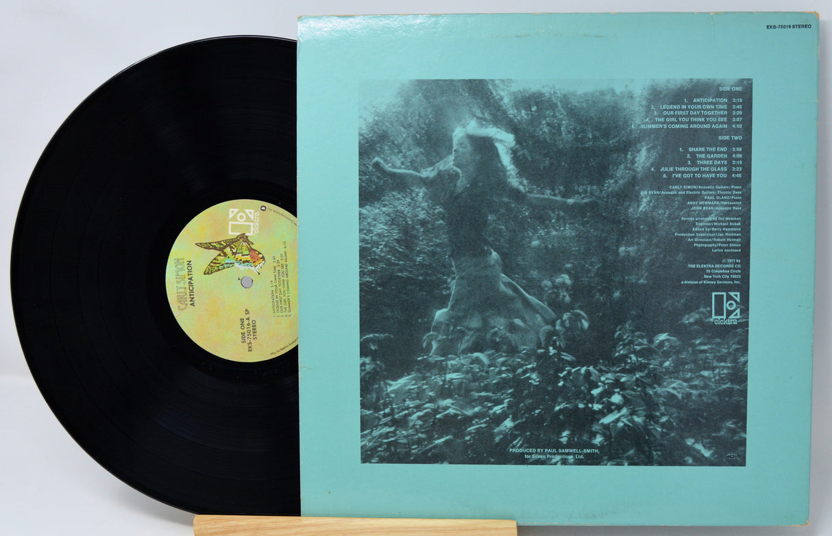 Vinyl record with a green cover featuring an abstract design and text.