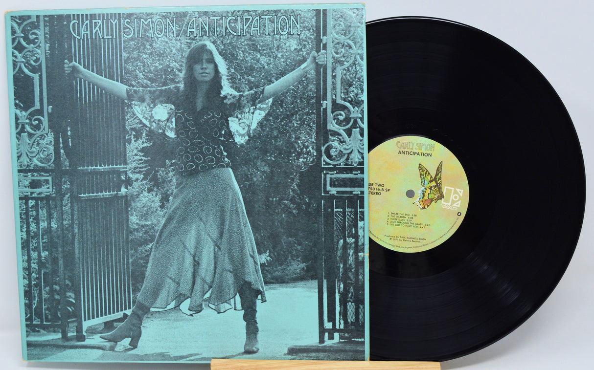 Vinyl record with cover featuring a person and butterfly design on a decorative background
