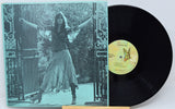 Vinyl record with cover featuring a person and butterfly design on a decorative background