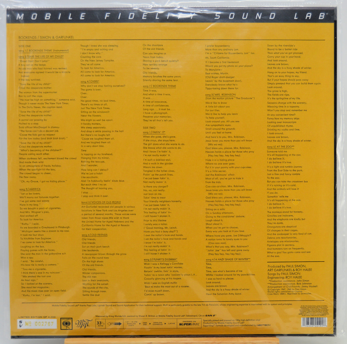 The back cover of a vinyl record sleeve, featuring a bright yellow background with dense black text listing track information and credits. The top banner reads 'MOBILE FIDELITY SOUND LAB'.