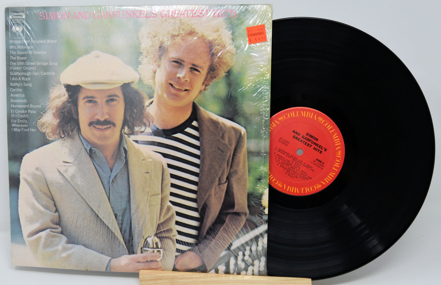 Vinyl record with cover featuring two men, one holding a glass, on a white background.