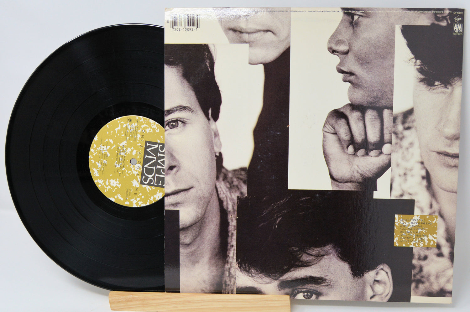 Vinyl record with a collage-style cover featuring black and white portraits.