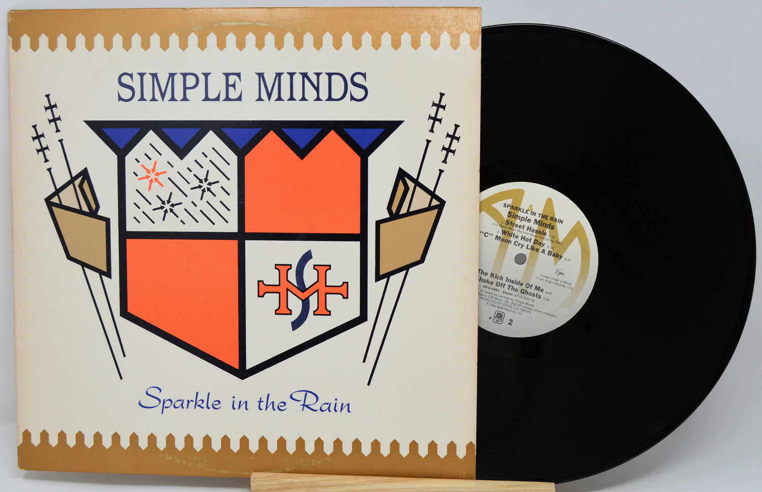 Vinyl record and cover for 'Sparkle in the Rain' by Simple Minds