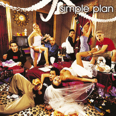 Simple Plan band members celebrating at a lively indoor party with streamers and vibrant decor