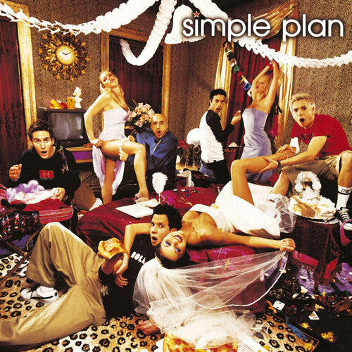 Simple Plan band members celebrating at a lively indoor party with streamers and vibrant decor