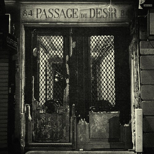 An old, dilapidated doorway with a sign above it reading 'Passage du Desir' in faded lettering, suggesting a historical or cultural significance.