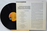Vinyl record with cover featuring text and a label