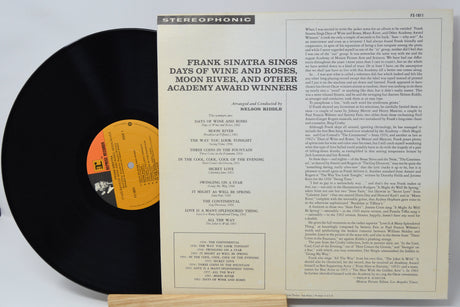 Vinyl record with cover featuring text and a label