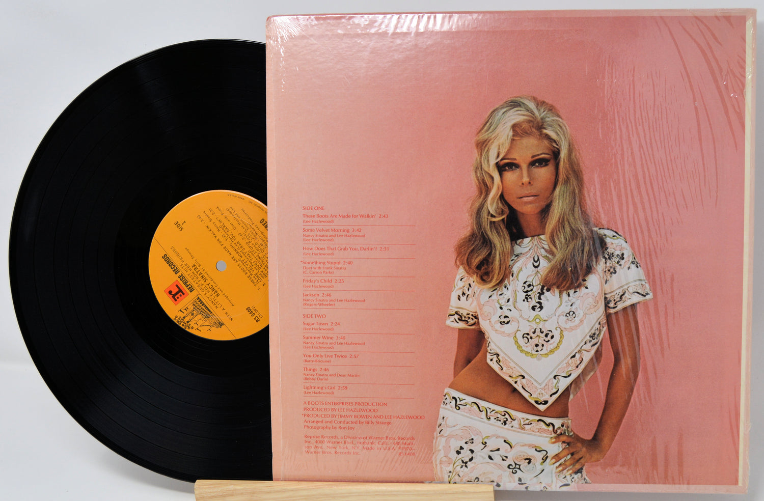 Vinyl record with a cover featuring a person on a pink background