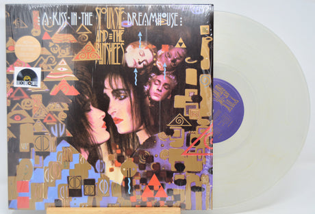 Clear Vinyl record 'Siouxsie The Banshees A Kiss In The Dreamhouse' with colorful cover featuring two faces and abstract designs.