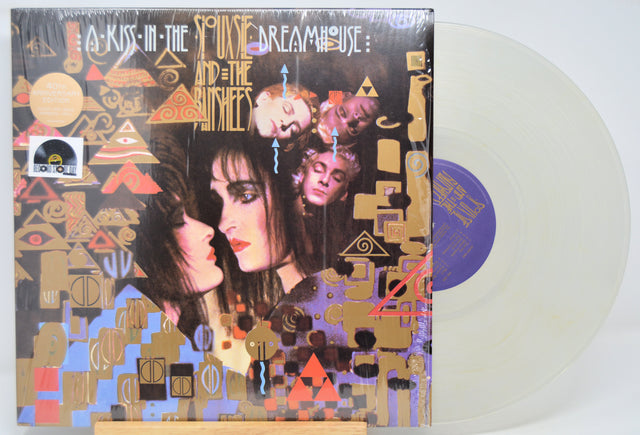 Clear Vinyl record 'Siouxsie The Banshees A Kiss In The Dreamhouse' with colorful cover featuring two faces and abstract designs.