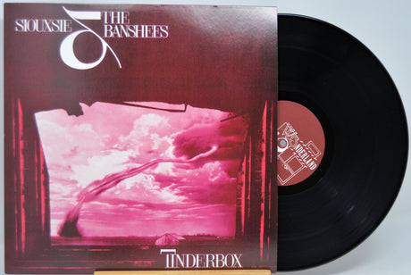 Black Vinyl record with cover featuring a pink sky and clouds, titled 'Tinderbox' by Siouxsie & the Banshees.