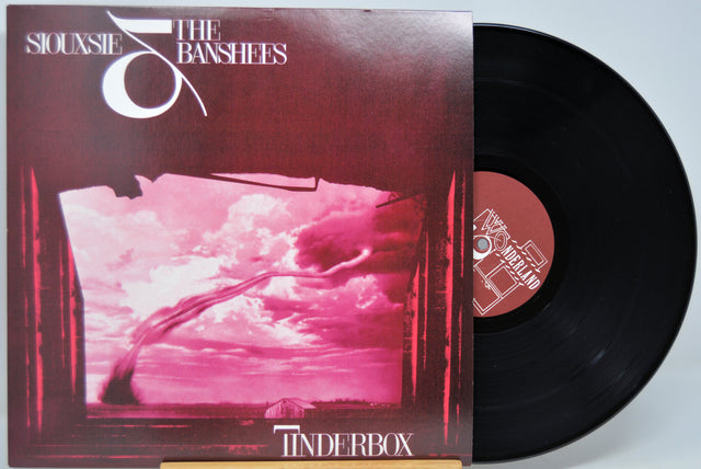 Black Vinyl record with cover featuring a pink sky and clouds, titled 'Tinderbox' by Siouxsie & the Banshees.