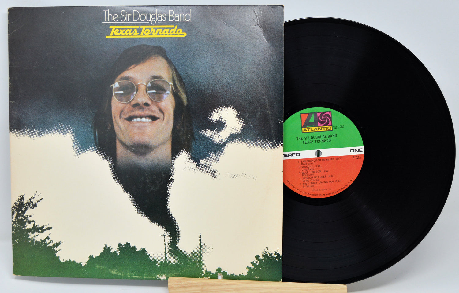 Vinyl record album for 'Texas Tornado' by The Sir Douglas Band, showing the illustrated cover sleeve and the black LP disc partially pulled out, with a visible colored center label.
