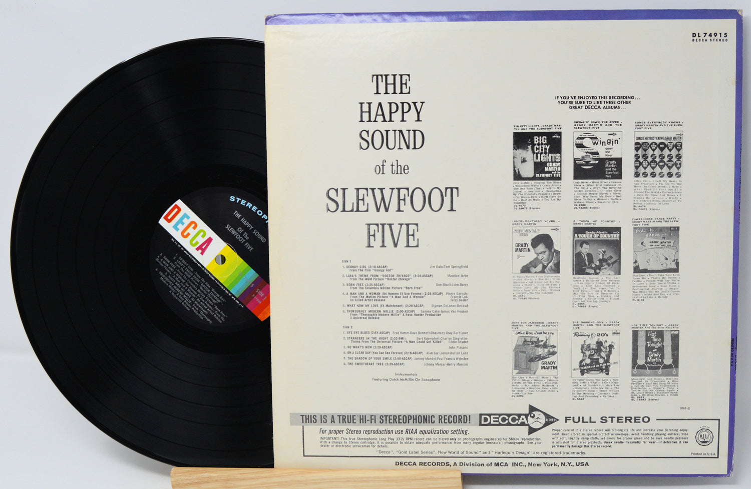 Vinyl record with cover displaying 'The Happy Sound of the Slewfoot Five' on a light gray background