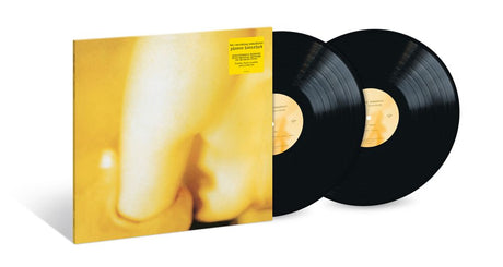A vinyl record album shown with its illustrated cover sleeve and two black records partially pulled out, on a clean white background.