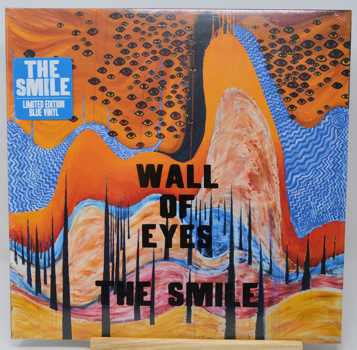 Vinyl record cover with abstract design and text 'The Smile' on a white background