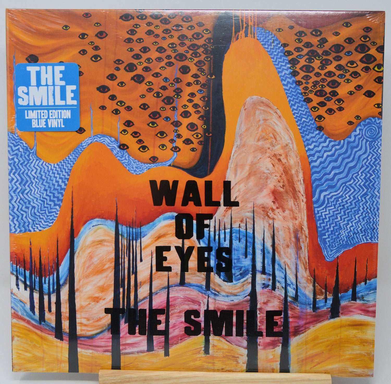 Vinyl record cover with abstract design and text 'The Smile' on a white background